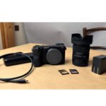 Essential accessories for Sony a6700 laid out on a table