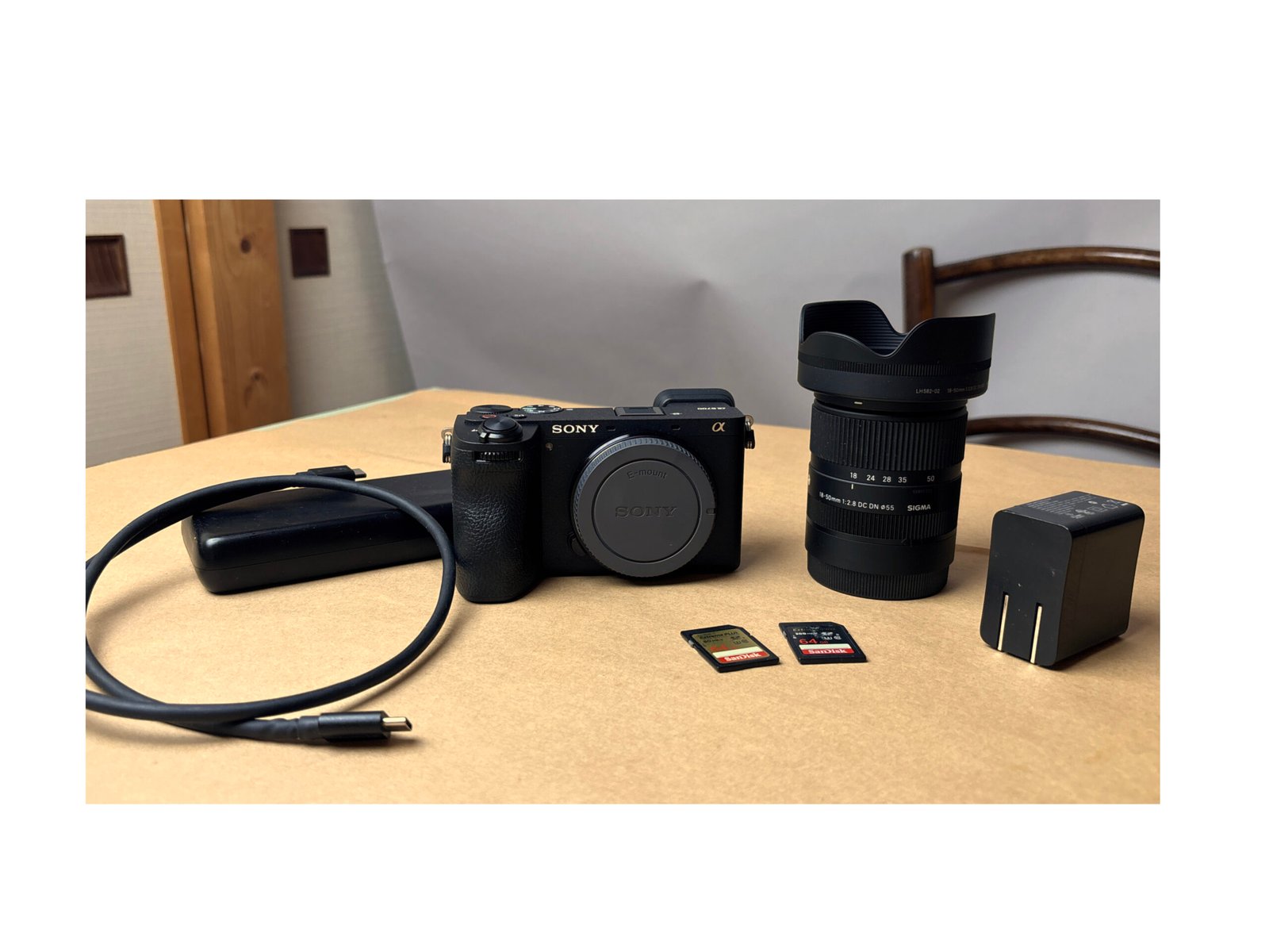 Essential accessories for Sony a6700 laid out on a table